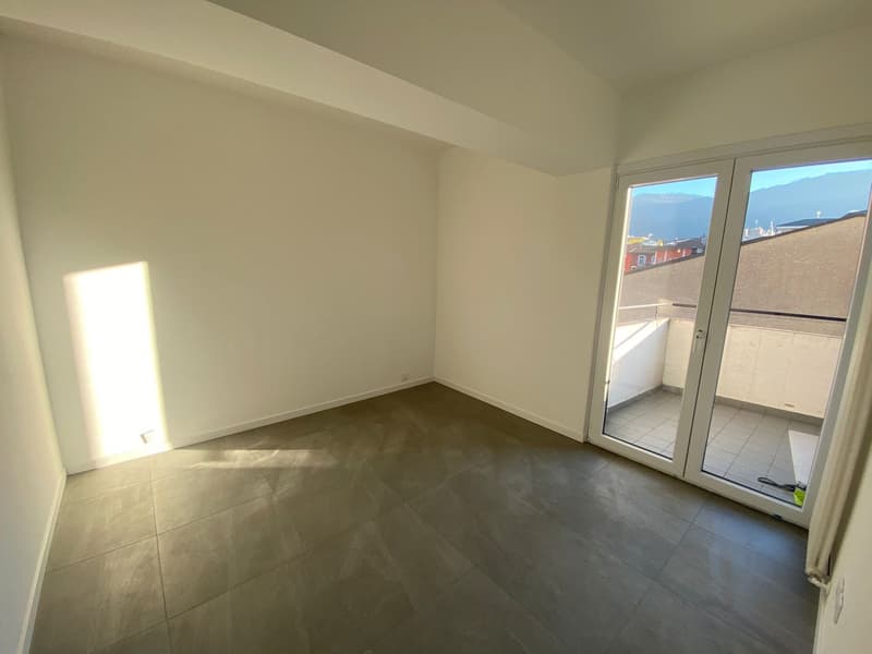 Empty room with sliding glass door to balcony