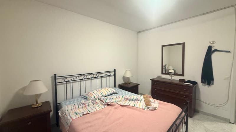 bed, nightstands, lamp, mirror, dresser, clothes