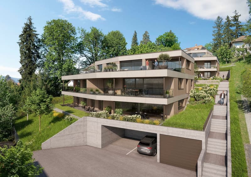 Modern multi-story house with multiple balconies, raised ground floor, and garage