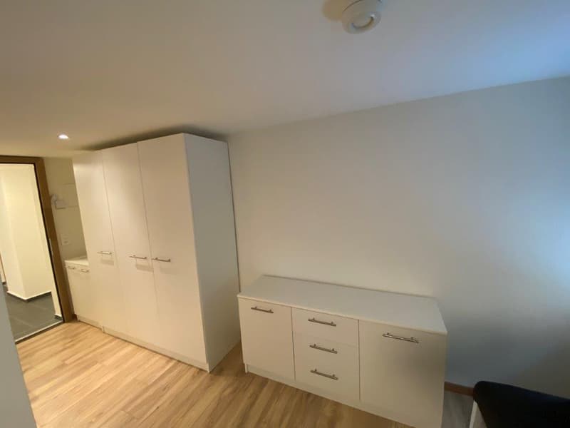 large white wardrobe, 4-drawer dresser, modern bathroom, tiled floor, white walls
