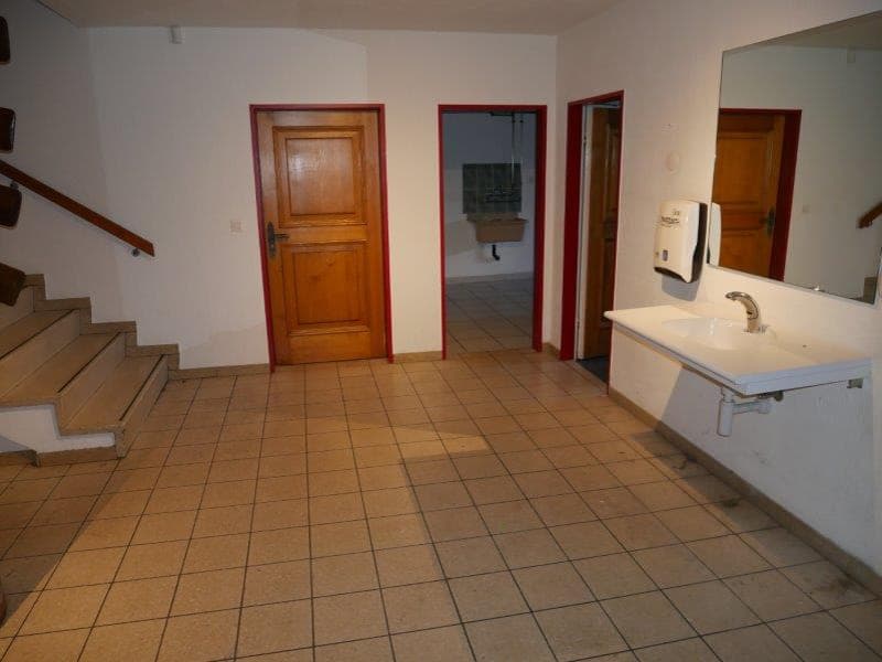 empty room, white walls, tiled floor, sink, faucet, mirror, hand soap dispenser, wooden door, staircase