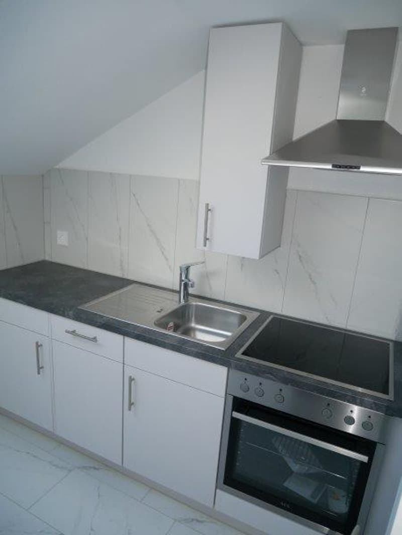 kitchen with white cupboards, granite countertop, stainless steel sink, integrated stove and oven, stainless steel extractor hood