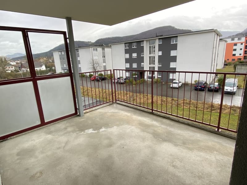 balcony, steel fence, view of a large parking area and mountains in the background