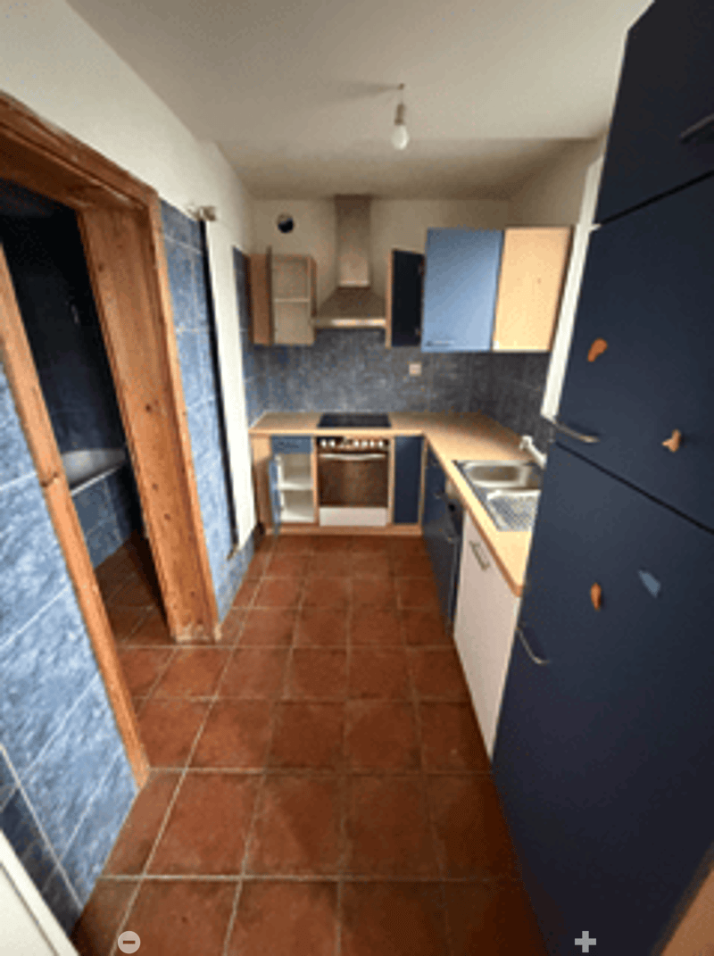 blue tiles, brown tiles, blue cabinets, sink, oven, washing machine