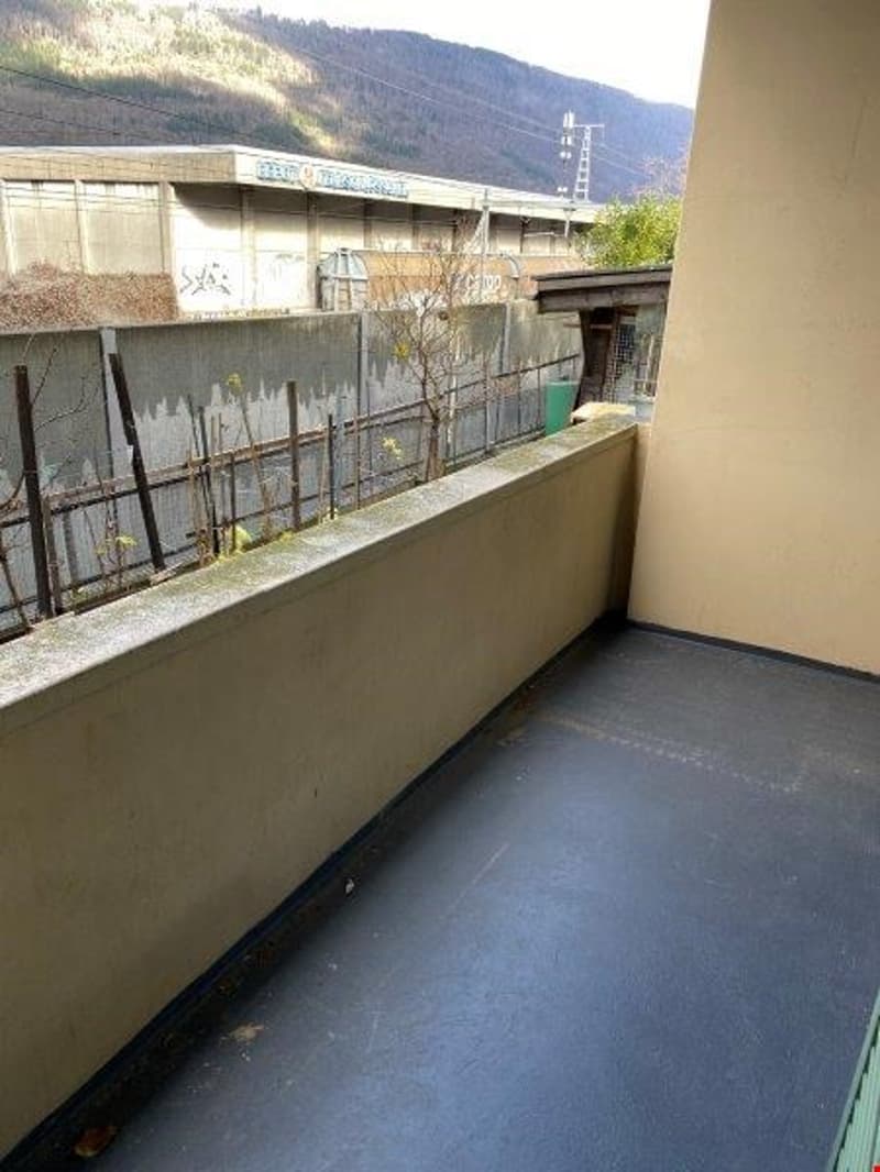 Balcony with concrete floor, no objects, metal railing, clear view