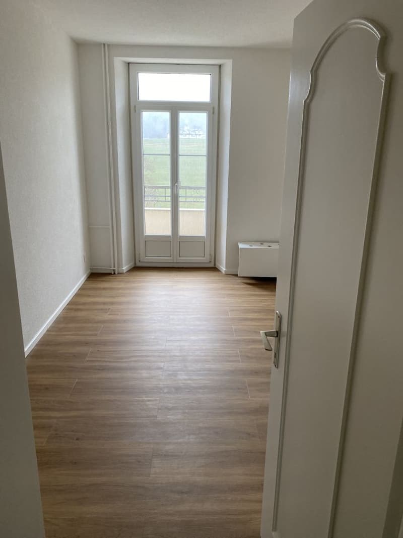 empty room, wooden floor, white walls, glass door, balcony, view of the outside