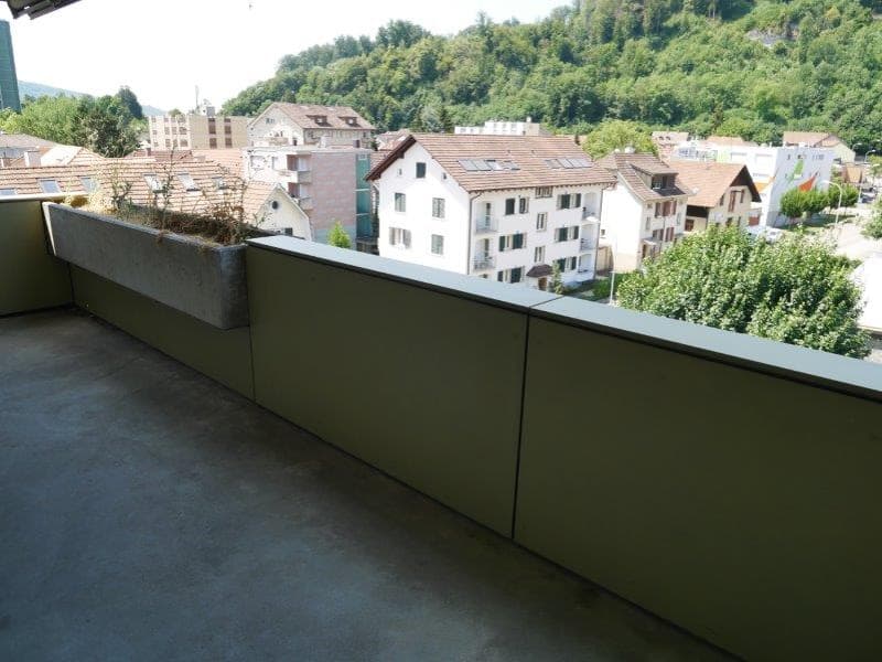 concrete balcony, metal railing, planter, view of the town