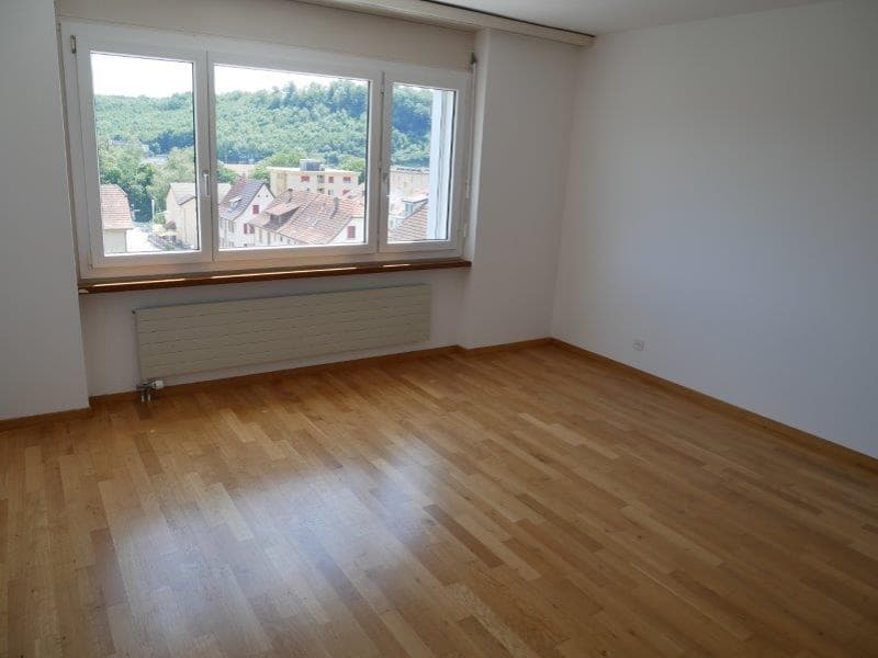empty room, wooden floor, large window, white walls, radiator