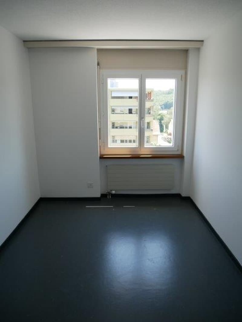 empty room, white walls, black floor, window with view