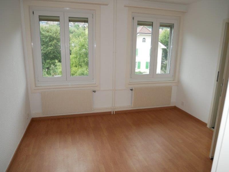 empty room, wooden floor, white walls, two windows, radiators