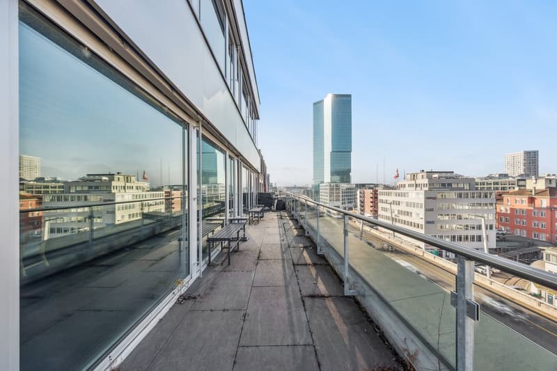 Balcony with benches, glass walls, city view