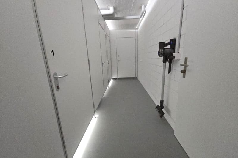 storage room, clean, lined walls, concrete floor, number 1 on door