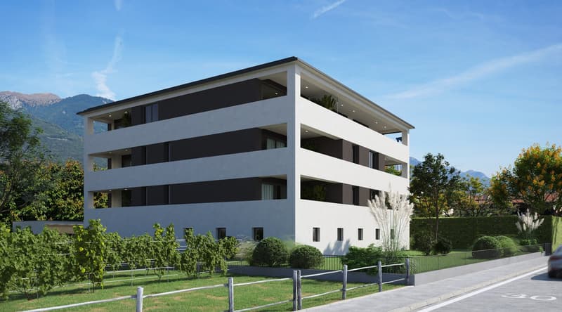 3-story modern apartment building with a white exterior and black accents, surrounded by landscaped gardens and parking spaces