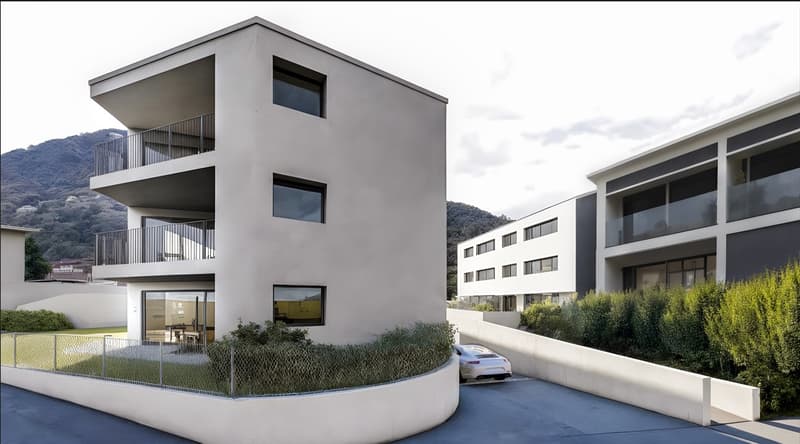 3-story modern apartment building with balconies, large windows, and a parking area in the foreground