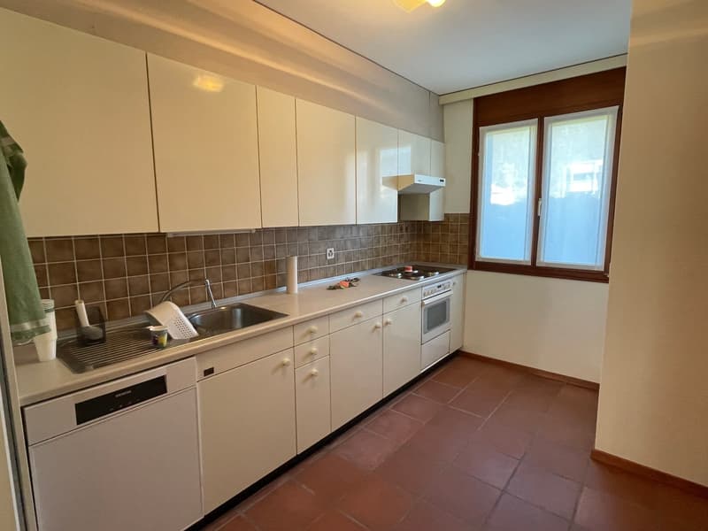 kitchen with all white cabinets, gas stove, oven, sink, windows with curtains, dishwasher