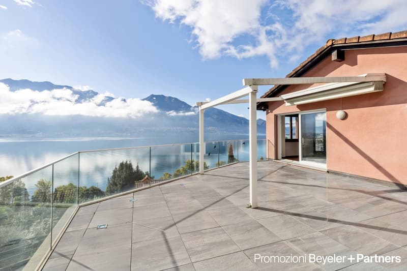Terrace with a glass railing and a pergola