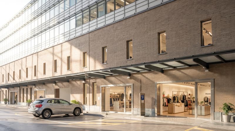 modern building, glass windows, brick wall, car parked in front, awnings, potted plants
