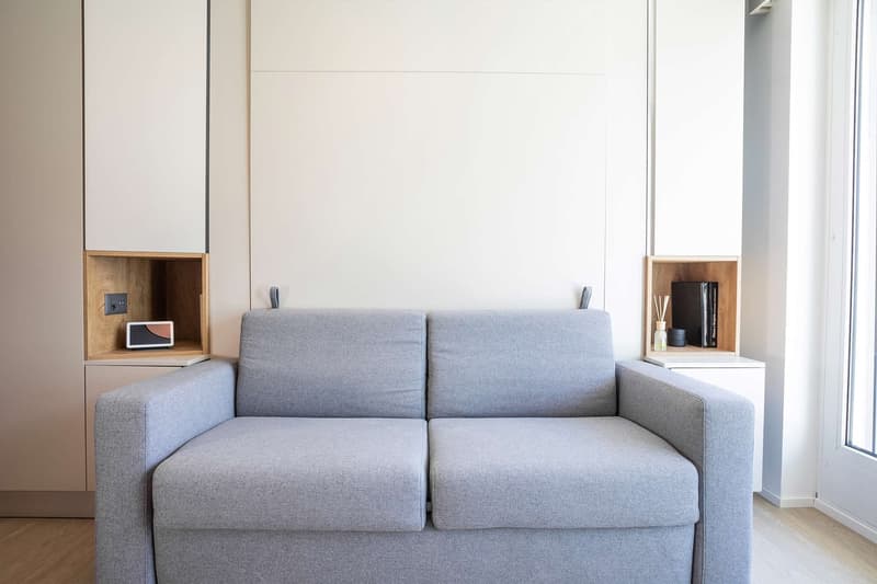 Gray sofa, built-in shelves, large window