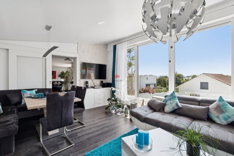 Erweitertes Wohnzimmer mit grossen Fensterfronten und traumhafter Aussicht - Erdgeschoss