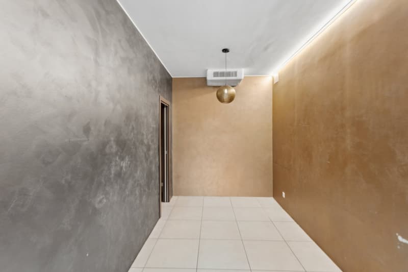 Gray and beige walls, white tiled floor, ceiling lamp
