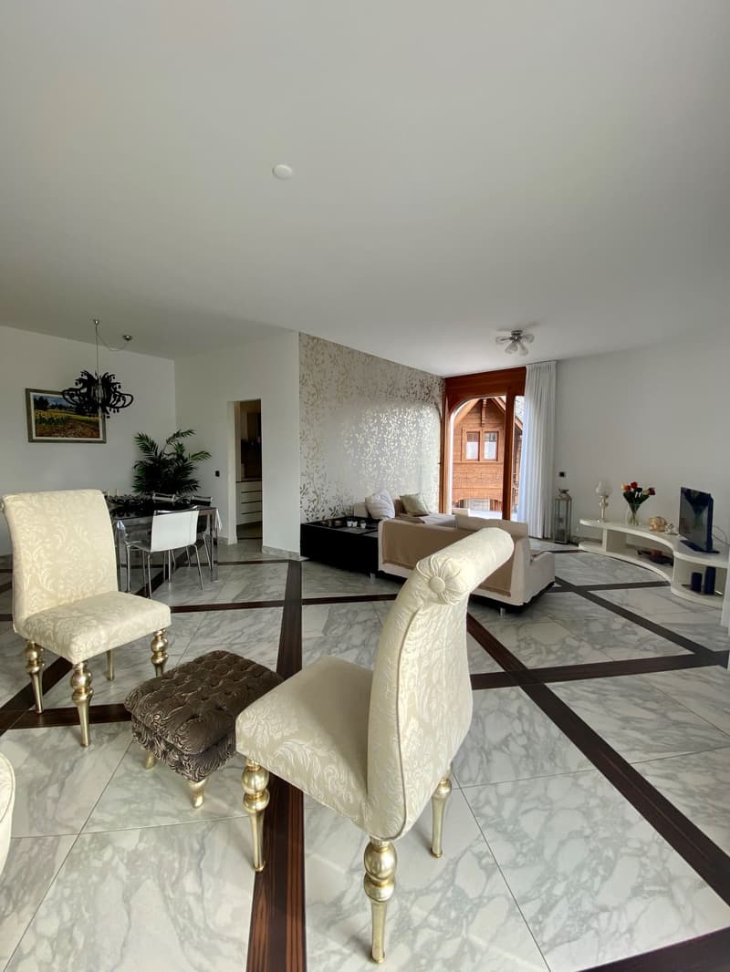 modern white interior, marble flooring, elegant chairs, coffee table, ceiling fan, arched doorway leading to living area