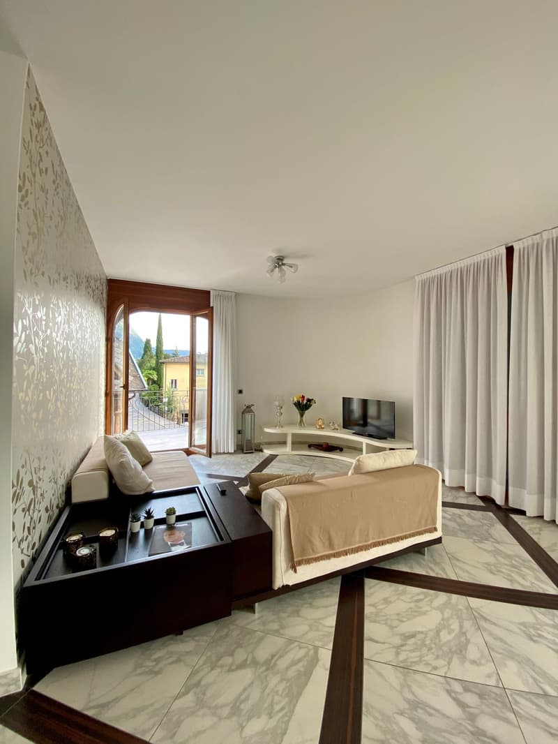 modern living room, marble floor, white walls, large glass doors, balcony, tv, white curtains, couch, coffee table, white table, flower vase