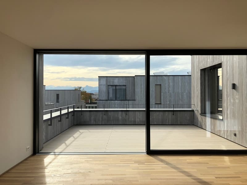 large sliding glass doors, wooden floor, balcony with railings, view of the outside
