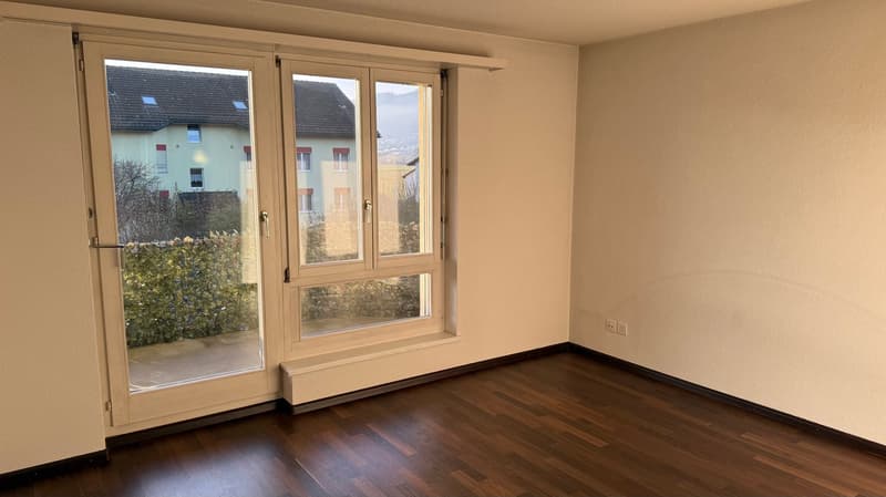 empty room, large glass doors, balcony, hardwood floors, white walls, outdoor view
