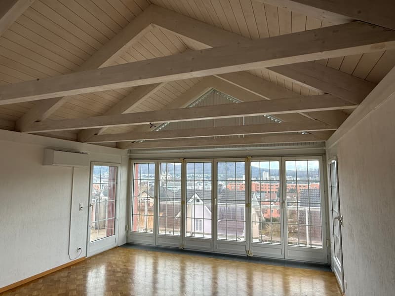 wooden ceiling, wooden floor, large windows, city view