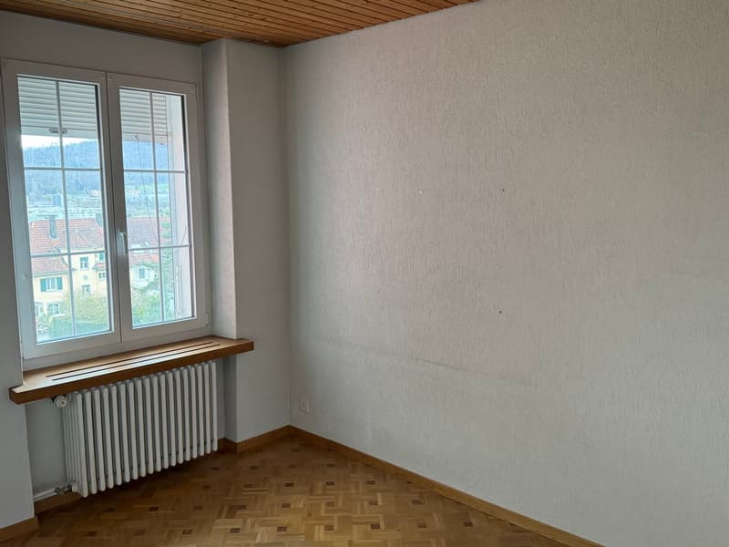empty room, white walls, wooden floor, window with white shutters, radiator