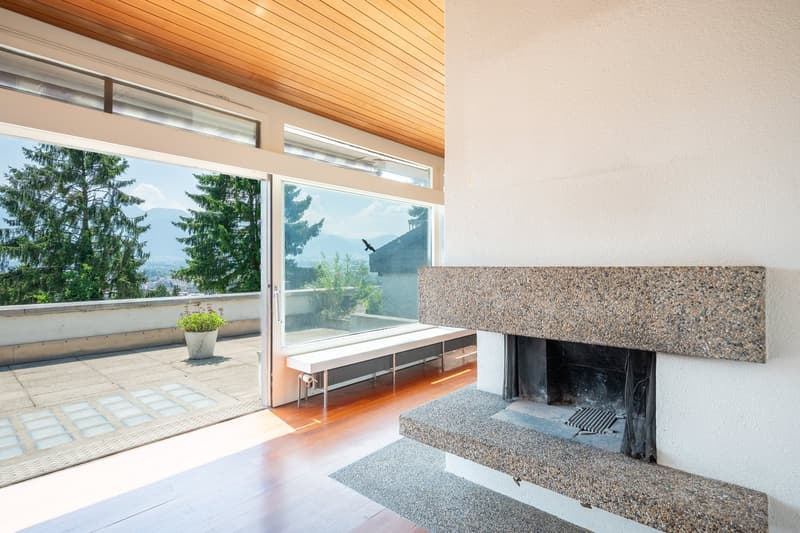 large windows, fireplace, wooden floor, balcony, view of trees and mountains