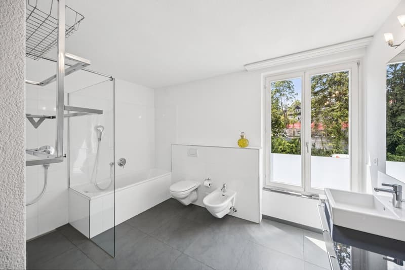 white tiles, glass walk-in shower, bathtub, modern white sink, bidet, toilet, glass window