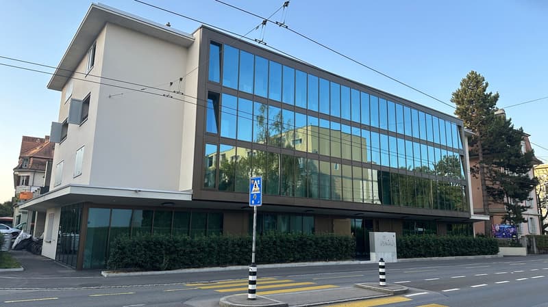 3 story building, glass facade, modern architecture, beige and brown color scheme