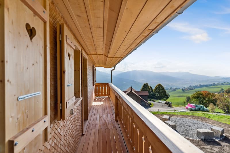 wooden floor, railings, wooden doors, view of mountains
