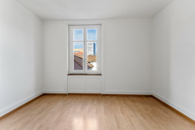 empty room, white walls, wooden floor, window with view