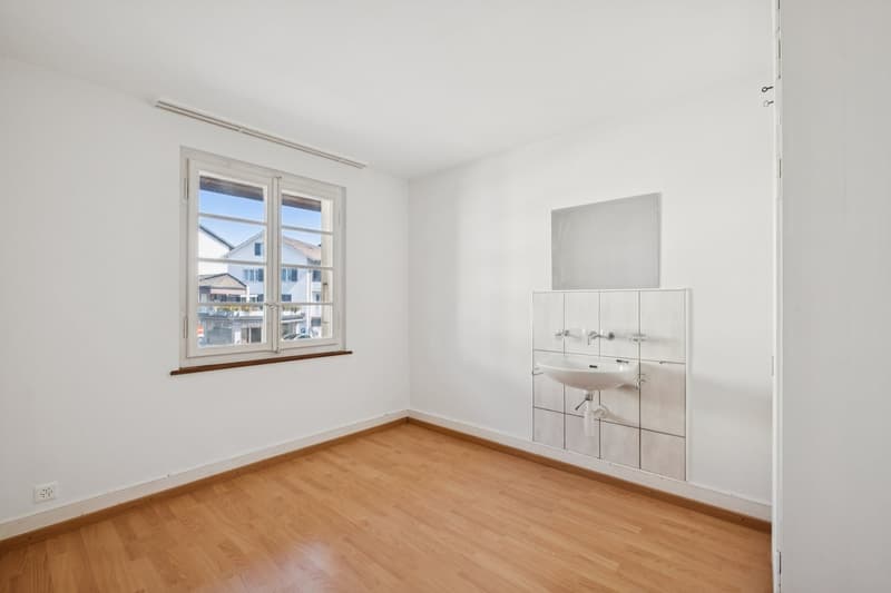empty room, white walls, wooden floor, window, sink