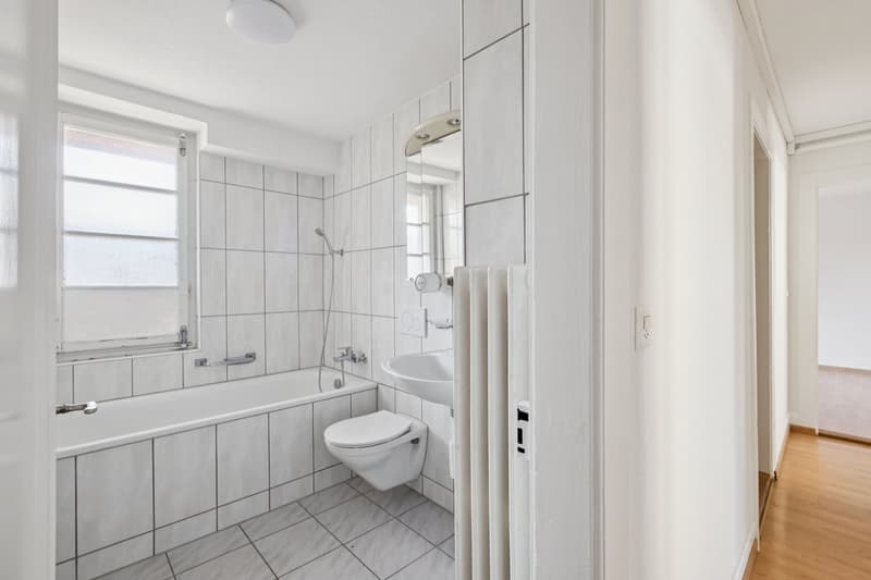 Bathroom with bathtub, toilet, sink, mirror, and shower