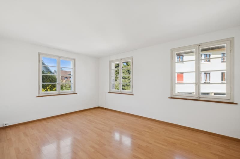 empty room, wooden floor, white walls, three windows, power outlet