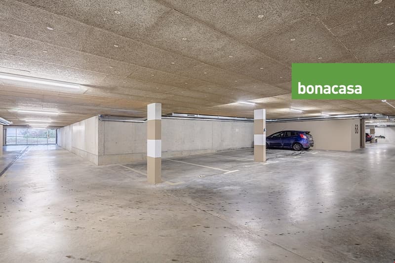 underground parking space with a blue car parked, parking place