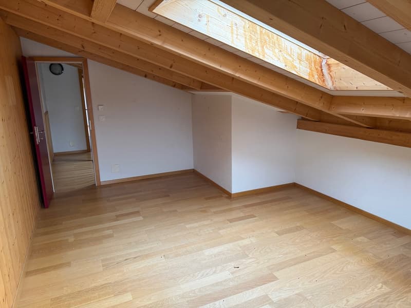empty room with wooden ceiling, wooden floor, small skylight