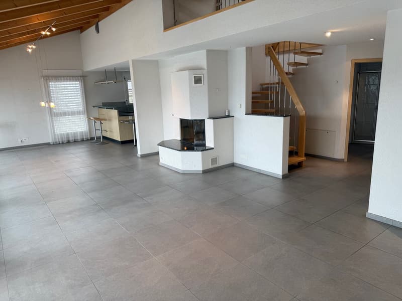 spacious room with tile flooring, central fireplace, staircase