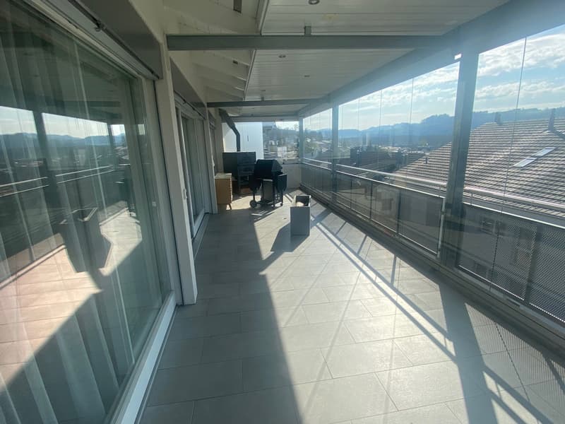 Tiled floor, glass walls, outdoor grill, panoramic city view