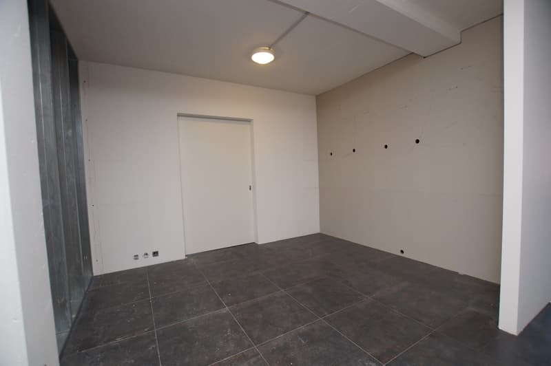 empty room, white walls, tiled floor, ceiling light, door