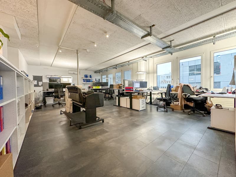 Office room with gray floor, gray walls, cabinets, office desks, chairs, computers, printer