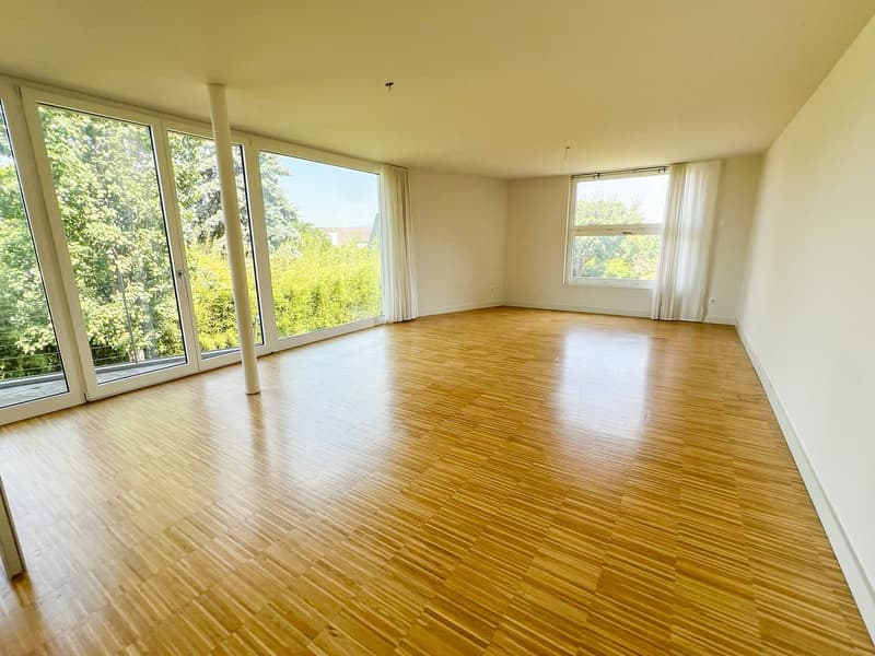 large room, wooden floor, large windows, white walls, white curtains