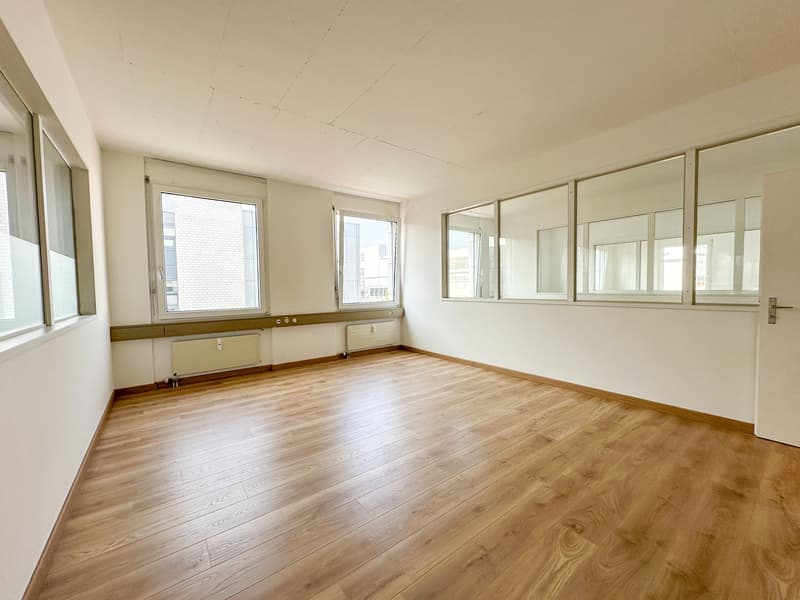 empty room, wooden floor, large windows, white walls, radiators
