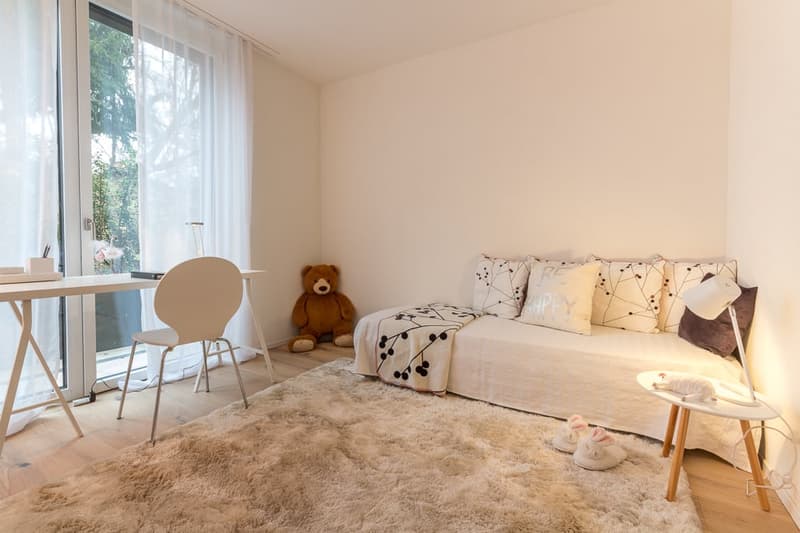 modern styled bedroom with bed, desk, chair, rug, decorative pillow, teddy bear, white furniture