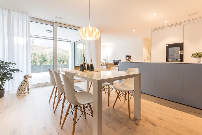White modern dining set, wooden floor, glass balcony doors, white walls, lamps