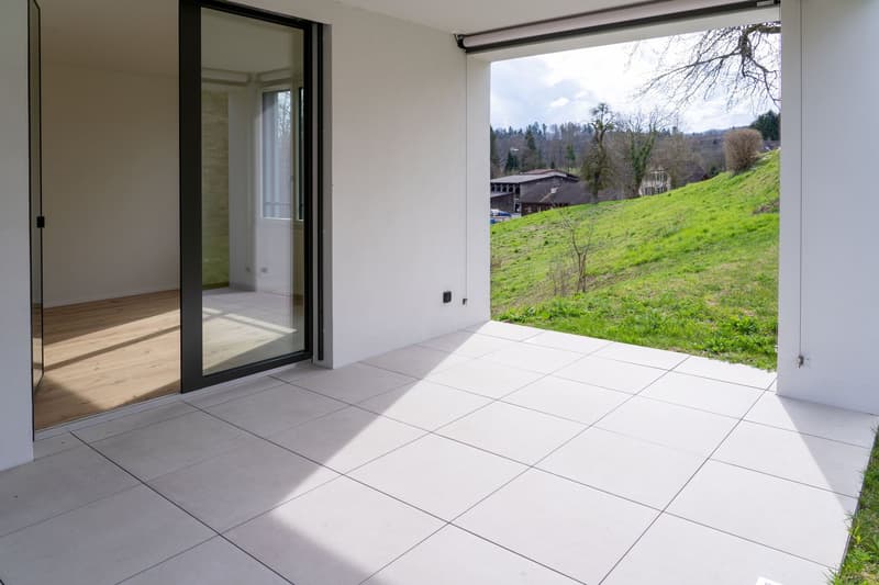 large glass doors, tiled floor, wooden floor, view of a grassy hill