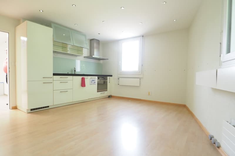 modern kitchen, green wall, hardwood floor, open window, white ceiling, white cabinets, black countertops, kitchen appliances
